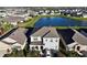 An aerial view of a beautiful home next to a scenic pond in a quiet neighborhood at 17119 Harvest Moon Way, Bradenton, FL 34211