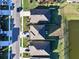 An aerial view of several homes with well-maintained lawns in a quiet neighborhood near a beautiful pond at 17119 Harvest Moon Way, Bradenton, FL 34211