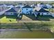 Aerial view of a fenced backyard that backs onto a scenic pond, with a well-maintained lawn at 17119 Harvest Moon Way, Bradenton, FL 34211