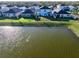 Backyard of a home that backs onto a tranquil pond, with a fenced yard and seating area at 17119 Harvest Moon Way, Bradenton, FL 34211