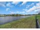 Scenic view of the backyard overlooking a tranquil lake, perfect for relaxation at 17119 Harvest Moon Way, Bradenton, FL 34211