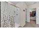 Bright bathroom featuring a shower with patterned curtain and a walk-in closet at 17119 Harvest Moon Way, Bradenton, FL 34211