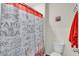 Charming bathroom with a decorative shower curtain, toilet, and a vibrant color accent for a cheerful space at 17119 Harvest Moon Way, Bradenton, FL 34211