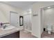 Bright bathroom with a double sink vanity, decorative mirror and a shower with patterned curtain at 17119 Harvest Moon Way, Bradenton, FL 34211