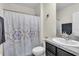 Bathroom featuring a shower with patterned curtain, a vanity and mirror with dark hardware at 17119 Harvest Moon Way, Bradenton, FL 34211