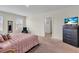 Bedroom with a bed, dark furniture, carpet flooring, and soft natural light at 17119 Harvest Moon Way, Bradenton, FL 34211