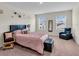 Bedroom with a bed, a large window, two chairs and soft natural light at 17119 Harvest Moon Way, Bradenton, FL 34211