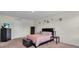 Bedroom with a bed, dark furniture, carpet flooring, and soft natural light at 17119 Harvest Moon Way, Bradenton, FL 34211