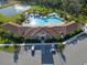Aerial view of a community center showcasing a stunning pool, ample parking, and meticulously landscaped grounds at 17119 Harvest Moon Way, Bradenton, FL 34211