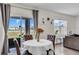 Cozy dining area featuring a round table, tufted chairs, and sliding glass doors to an outdoor space at 17119 Harvest Moon Way, Bradenton, FL 34211