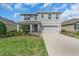 Charming two-story home with a well-manicured lawn and a welcoming front porch at 17119 Harvest Moon Way, Bradenton, FL 34211