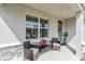 Relaxing front porch setting with comfortable seating and attractive stone accents at 17119 Harvest Moon Way, Bradenton, FL 34211
