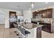 This kitchen features a central island with counter seating, stainless steel appliances, and modern pendant lighting at 17119 Harvest Moon Way, Bradenton, FL 34211