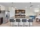 Modern kitchen features a granite island with seating, stainless steel appliances, and dark wood cabinetry at 17119 Harvest Moon Way, Bradenton, FL 34211