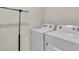 Functional laundry room with a washer and dryer, offering convenience and efficiency for household chores at 17119 Harvest Moon Way, Bradenton, FL 34211