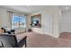Well-lit living room with comfortable seating, entertainment setup, and serene views from the large window at 17119 Harvest Moon Way, Bradenton, FL 34211