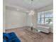 Bright living room with a glass table, comfortable blue sofa and a window with bright light at 17119 Harvest Moon Way, Bradenton, FL 34211