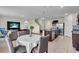 Open concept living space features dining area, Gathering room, kitchen, and stairwell to the second floor at 17119 Harvest Moon Way, Bradenton, FL 34211