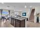 Open concept living space features dining area, Gathering room, kitchen, and stairwell to the second floor at 17119 Harvest Moon Way, Bradenton, FL 34211
