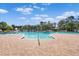 Community pool with ample seating, pool furniture and tropical landscaping at 17119 Harvest Moon Way, Bradenton, FL 34211