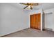 Bedroom with a ceiling fan, and a closet with double louvered doors at 2004 49Th E Ave, Bradenton, FL 34203