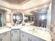 Bathroom boasts expansive mirrors over and sinks with a separate toilet and shower area at 26137 Dunedin Ct, Punta Gorda, FL 33983