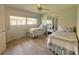 Bedroom with laminate flooring, two twin beds and light green walls at 26137 Dunedin Ct, Punta Gorda, FL 33983