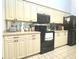 Well-maintained kitchen featuring neutral cabinets and essential appliances at 26137 Dunedin Ct, Punta Gorda, FL 33983
