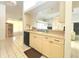 Traditional kitchen features bright cabinets, tiled floor, and a pass through to the living area at 26137 Dunedin Ct, Punta Gorda, FL 33983
