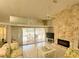 Comfortable living room showcasing a stone fireplace and scenic views of the patio at 26137 Dunedin Ct, Punta Gorda, FL 33983