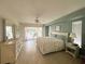 Spacious main bedroom features light green walls, a large window, and access to the lanai at 26137 Dunedin Ct, Punta Gorda, FL 33983