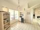 Bright home office features tile floor, large window, built-in desk and shelving, plus an attractive pendant light at 26137 Dunedin Ct, Punta Gorda, FL 33983