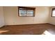 A bright bedroom featuring laminate floors and a large window at 2770 Temple Street, Sarasota, FL 34239