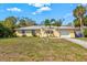 Charming single-story home with well-maintained lawn and attached garage under a sunny blue sky at 2824 Silk Oak Dr, Sarasota, FL 34232