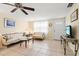 Cozy living room featuring tile flooring, comfortable seating, and a bright, airy atmosphere at 2824 Silk Oak Dr, Sarasota, FL 34232