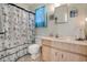 Bright bathroom featuring a shower with nautical-themed curtain and a single sink vanity at 2907 51St W Ave, Bradenton, FL 34205