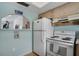 Kitchen featuring white appliances, natural wood cabinets, and an open view to the living room at 2907 51St W Ave, Bradenton, FL 34205