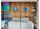 Functional laundry area with appliances, storage shelves, and a water heater at 2907 51St W Ave, Bradenton, FL 34205