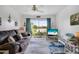 Living room with sliding glass doors opening to a patio with peaceful lake view at 2907 51St W Ave, Bradenton, FL 34205