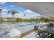 Outdoor community pool with sun loungers, table sets, and lush greenery at 2907 51St W Ave, Bradenton, FL 34205