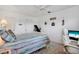 Calm bedroom with white furnishings, decorative touches, and access to closet and storage at 2907 51St W Ave, Bradenton, FL 34205