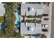 Bird's eye view of two-unit property with a shared kidney bean-shaped pool and tropical landscaping at 3007 Avenue E # A, Holmes Beach, FL 34217