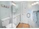 Clean bathroom with white cabinets, a modern vanity, and a glass shower door at 3007 Avenue E # A, Holmes Beach, FL 34217
