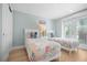 Bright bedroom featuring two twin beds, each adorned with colorful linens and decorative pillows at 3007 Avenue E # A, Holmes Beach, FL 34217