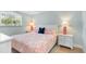 Comfortable bedroom features a queen bed, soft linens, and a sunlit window at 3007 Avenue E # A, Holmes Beach, FL 34217