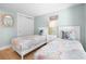 Bright bedroom with twin beds, coastal decor, and a closet for storage at 3007 Avenue E # A, Holmes Beach, FL 34217