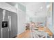 Open-concept view of dining room connecting to a well-lit living room and a kitchen at 3007 Avenue E # A, Holmes Beach, FL 34217