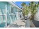 View of the home's exterior with a quaint outdoor seating area and lush landscaping at 3007 Avenue E # A, Holmes Beach, FL 34217