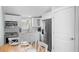 Bright, all-white kitchen with stainless steel appliances and cozy dining area, perfect for entertaining at 3007 Avenue E # A, Holmes Beach, FL 34217