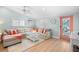 Bright living room featuring a comfortable sectional couch, hardwood floors, and natural light at 3007 Avenue E # A, Holmes Beach, FL 34217